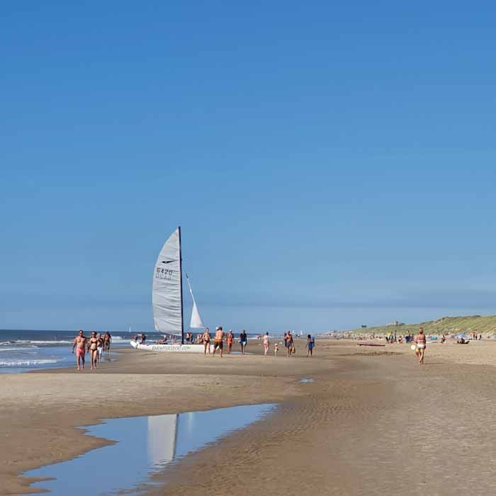 Bergen aan Zee beach - White sailing boat standing on the beach - Discover True Netherlands