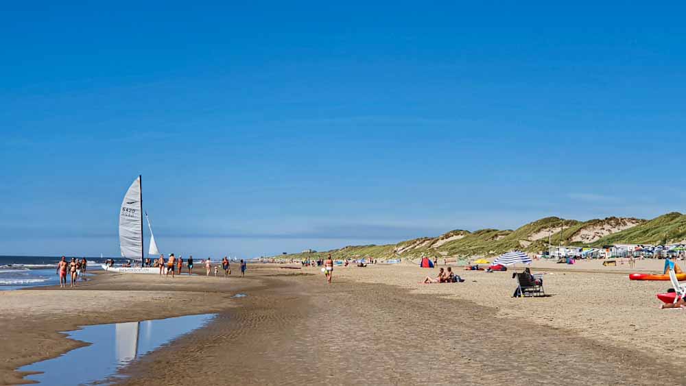Bergen aan Zee beach - White sailing boat standing on the beach - Discover True Netherlands - cover image