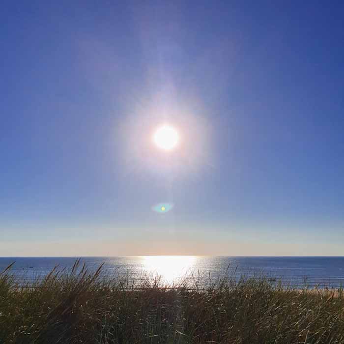 Egmond aan Zee beach - Sun rays on the sea - Discover True Netherlands