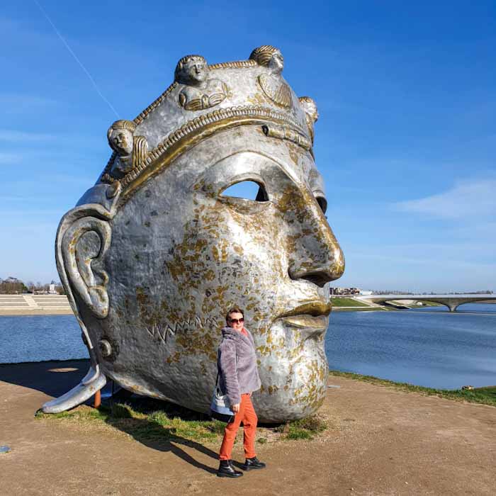 Nijmegen Roman mask- Standing in front of a giant head- Discover True Netherlands